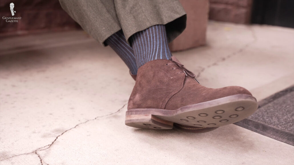 Gray trousers with blue-striped Fort Belvedere socks and brown shoes.