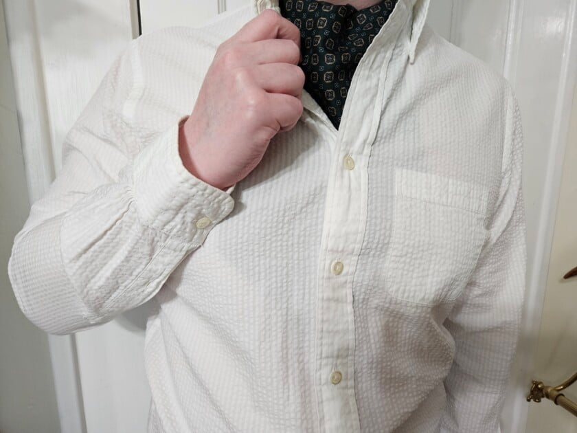 Photo of man wearing seersucker shirt with ascot 