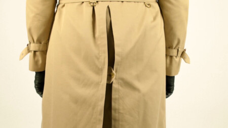 A pleated wedge features at the rear of many trench coats