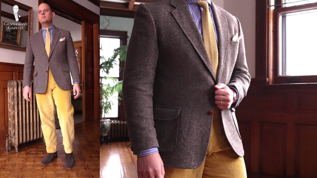 Raphael is wearing a Donegal tweed jacket, a blue and white striped shirt paired with high-rise yellow corduroy pants.