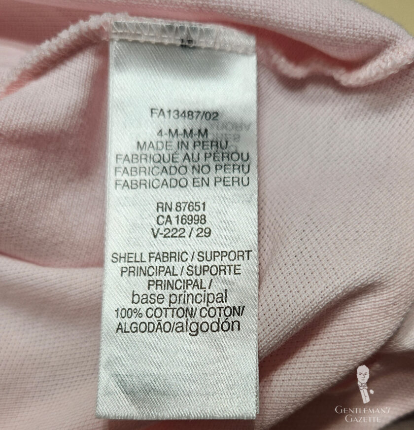 Photo of the The materials label for a Lacoste polo shirt