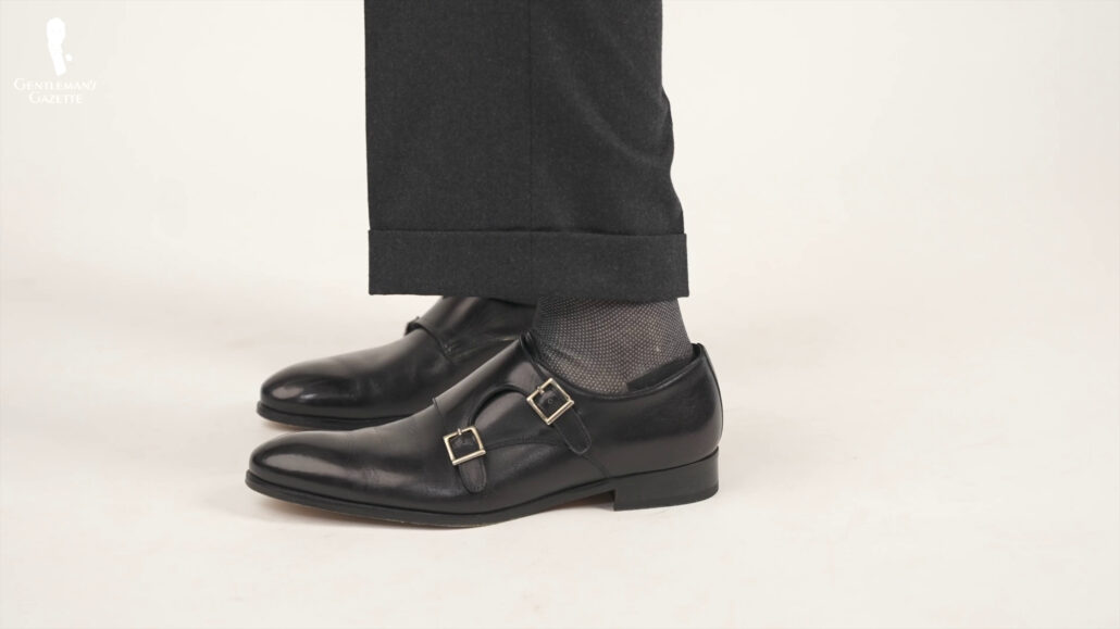 A dark grey trousers paired with a charcoal grey socks.