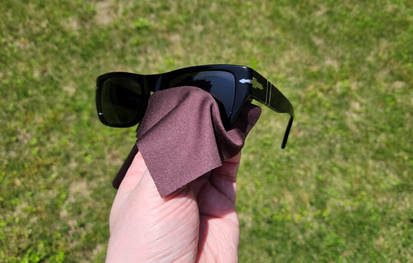 Photo of cleaning sunglasses with a microfiber cloth 