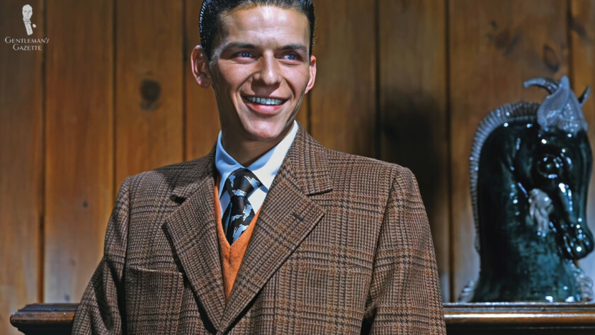 Photo of Frank Sinatra in brown sport coat with orange vest and bold silk tie