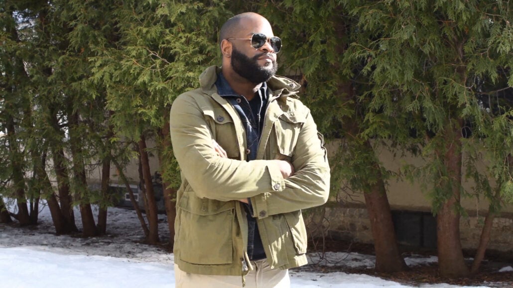 Kyle Wearing Green Jacket Navy Knitted Sweater Aviator Sunglasses Denim Jacket Photo of Kyle wearing green-jacket navy knitted sweater Aviator sunglasses denim jacket