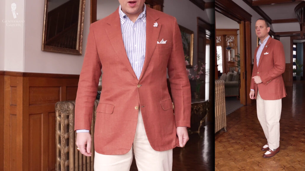 Raphael is wearing an orange Brioni paired with a sand-colored chinos.