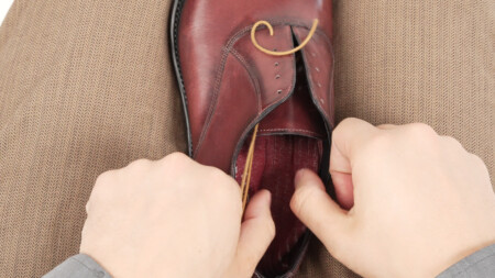 Step 1 is to pull the laces through the bottom eyelets
