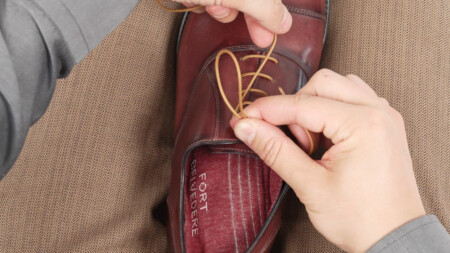 Step 3 is to pull the other lace toward the toe of your shoe