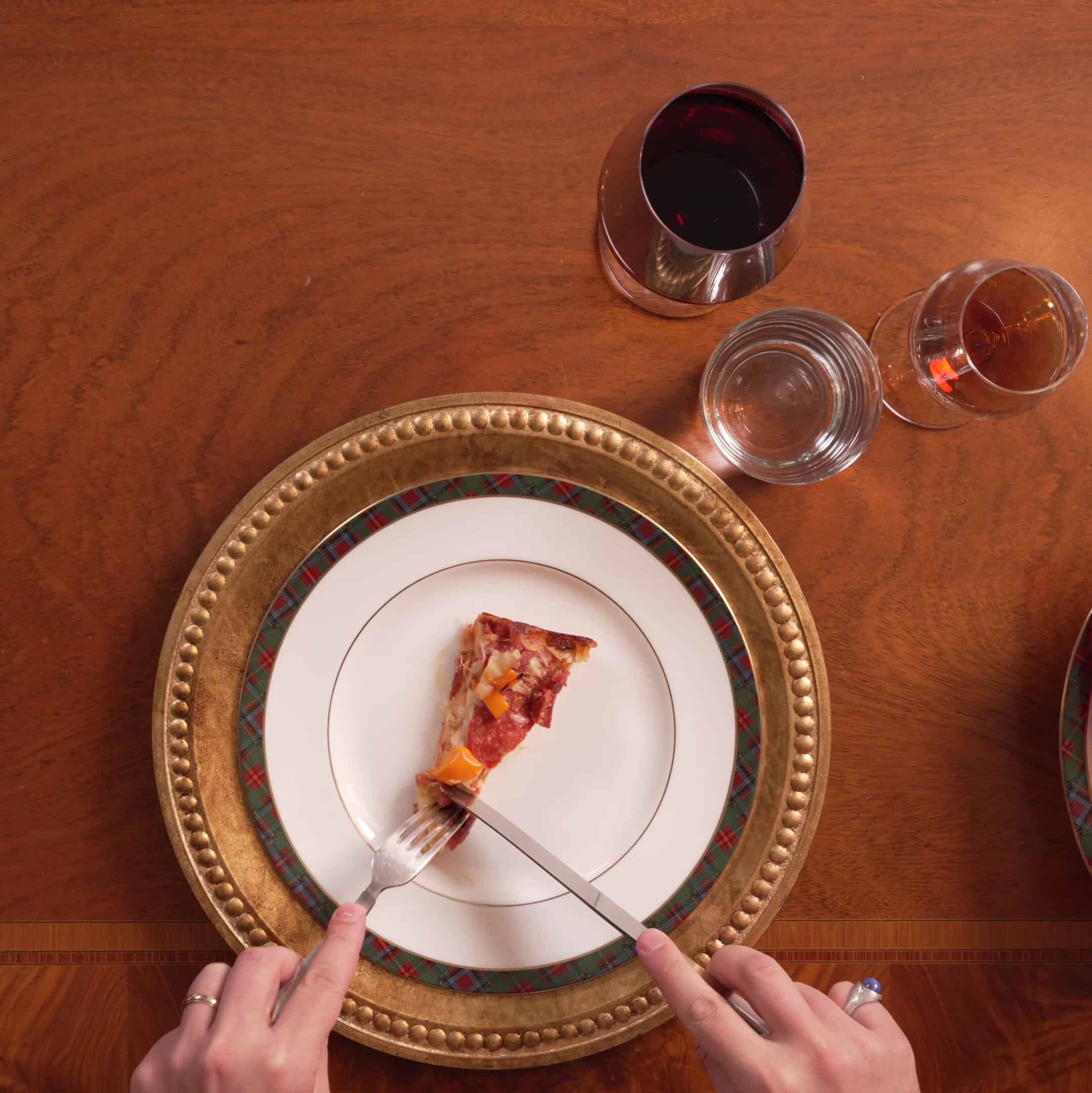 The Italians used their fork and knife when eating their pizza.