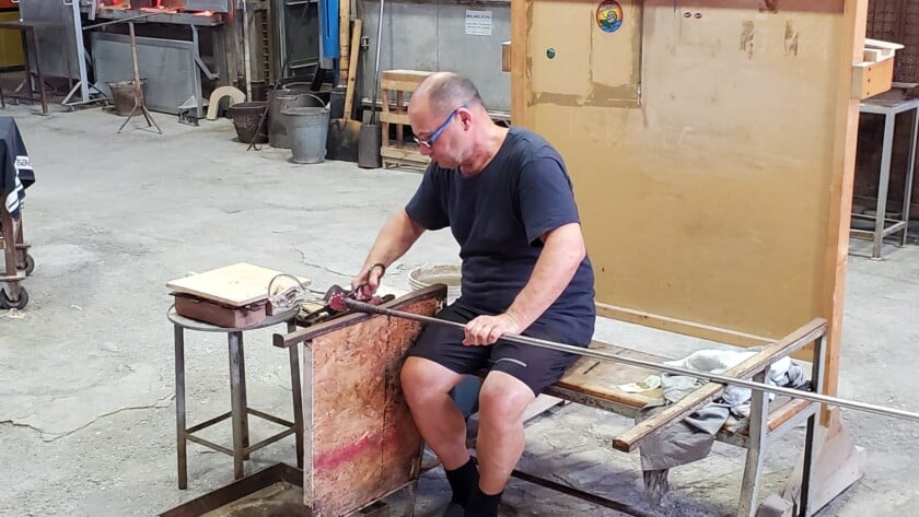 A Master Glass Worker Blows Glass In Murano Venice Italy Photo of a man blowing glass