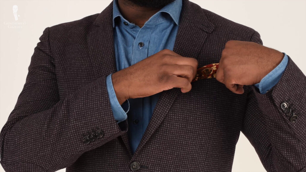 A take on more business casual look with this denim shirt and dark gray jacket.