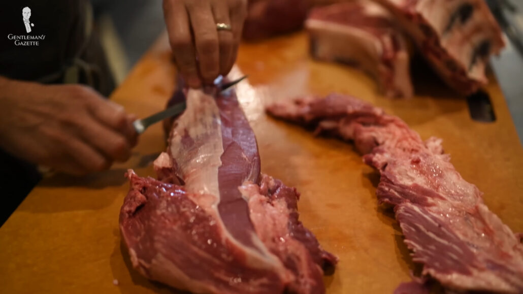 Photo of Butcher trimming fat from-cut of steak