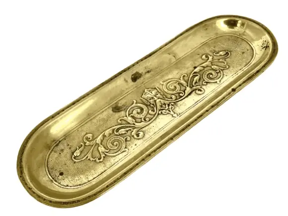 A gold pen tray with embellishments