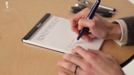 Photo of Preston writing with a ballpoint pen