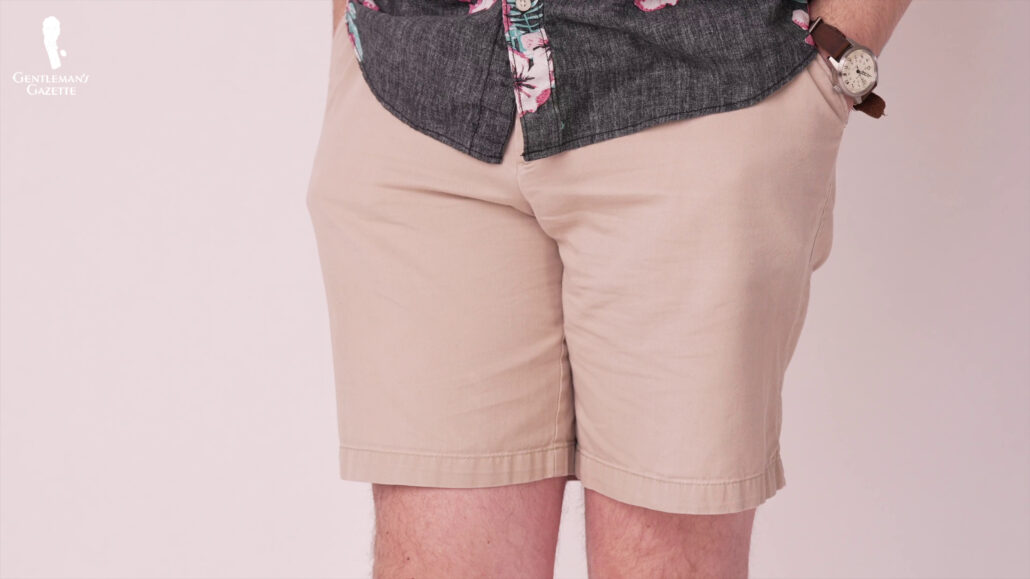 Nathan wearing khaki shorts and a dark floral pattern shirt