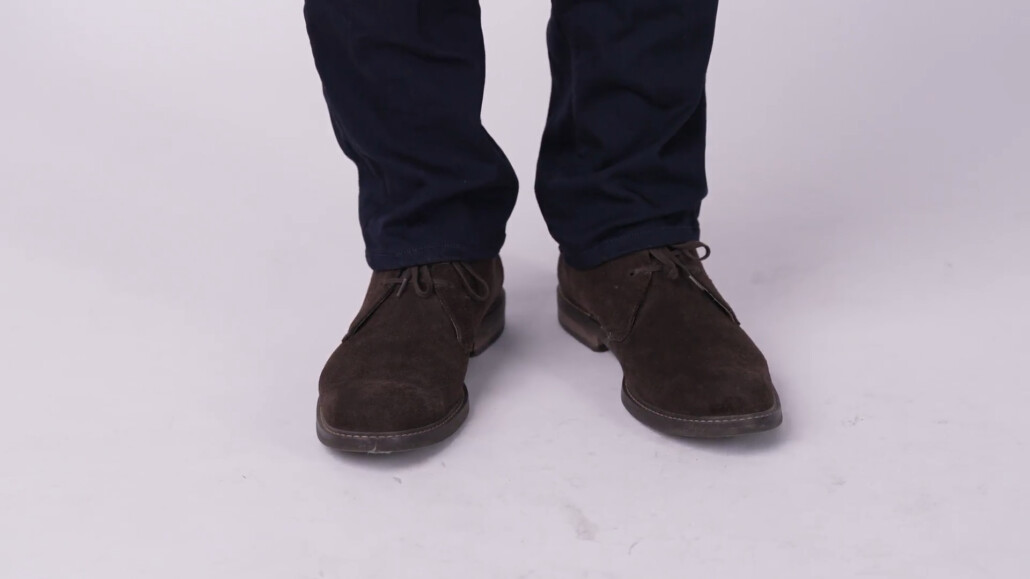 Photo of Chukka boots worn with dark navy trousers