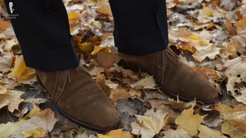 Photo of Chukka boots worn with fall ensemble dark navy trousers