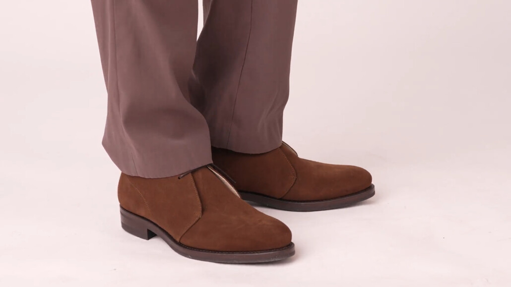 Photo of Chukka boots worn with medium brown trousers