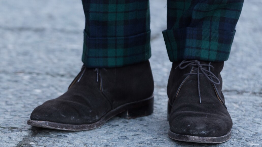 Photo of Dark chukka boots worn with plaid trousers cuffed