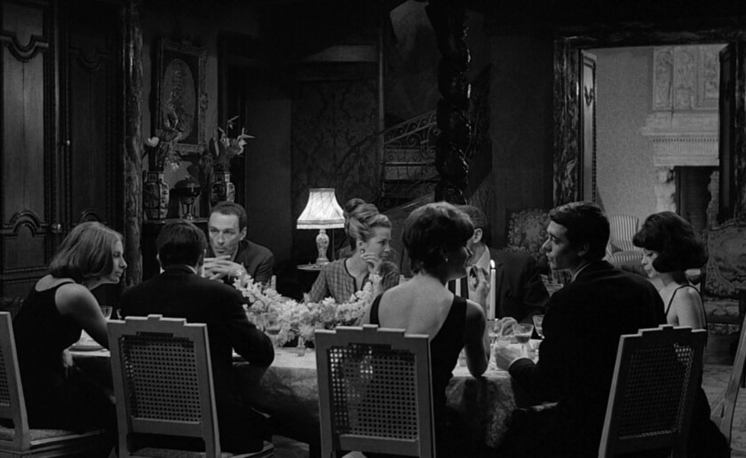 Film still of people around a dining room table