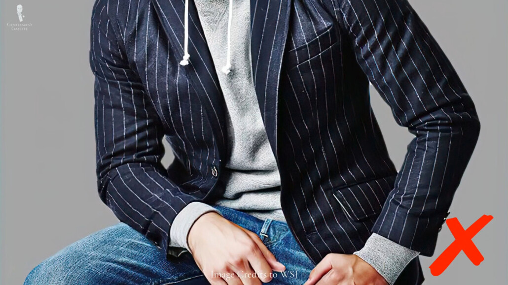 A pinstripe suit jacket and a pair of jeans combination is off.