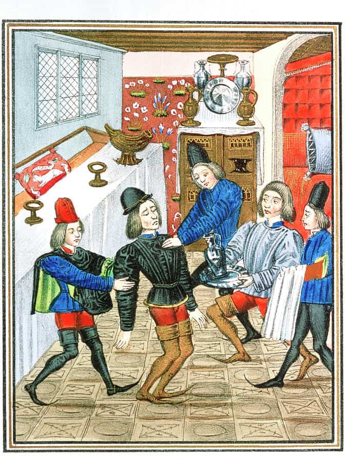 Medieval Art of a Heart Attack. Men are wearing footwear with cuffs.