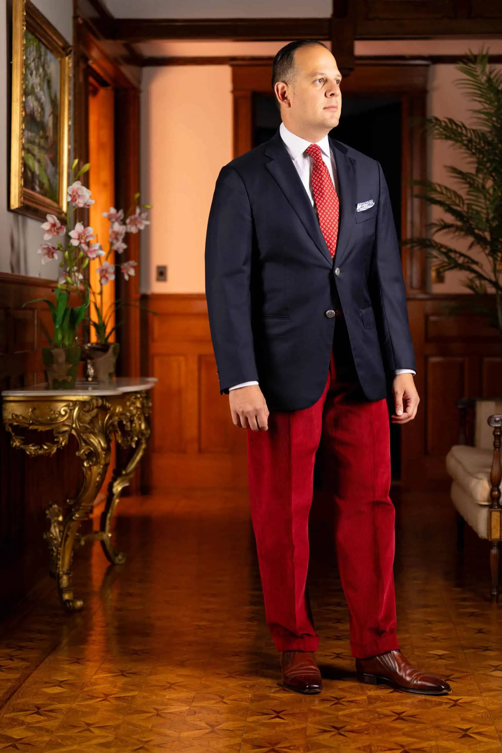 Photo of Raphael wearing Garnet Red corduroy with navy blazer and red tie