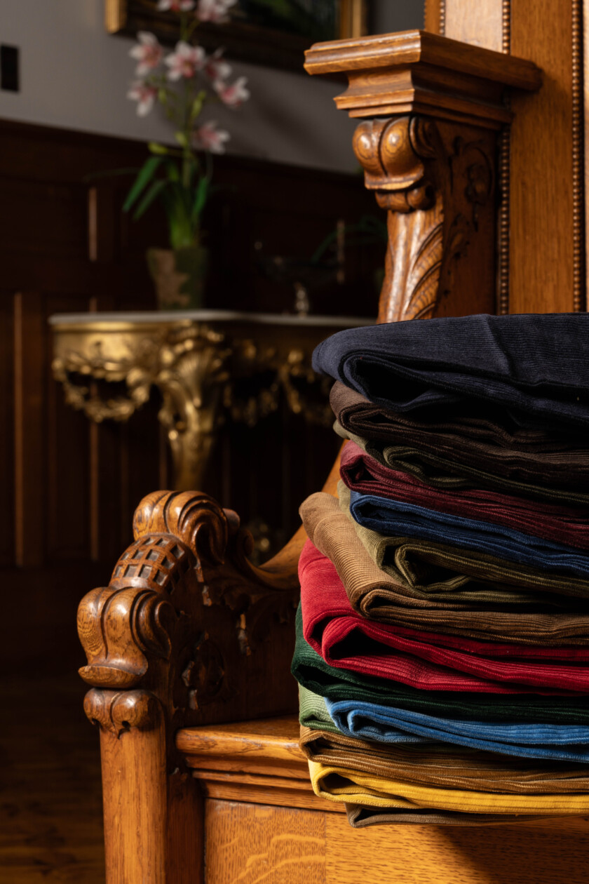 Photo of a stack of corduroy on an antique chair