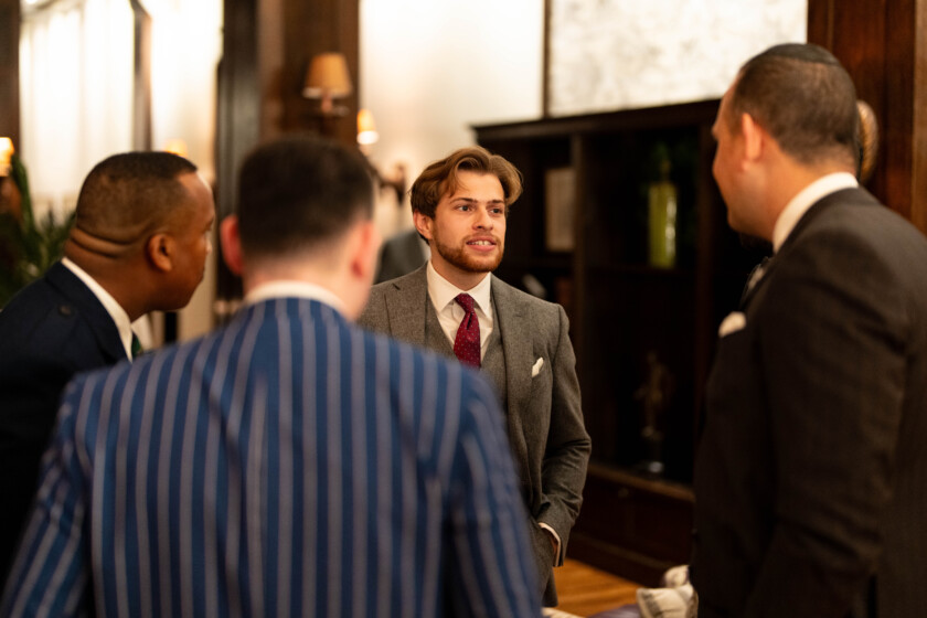 Photo of men chatting at a cocktail party 