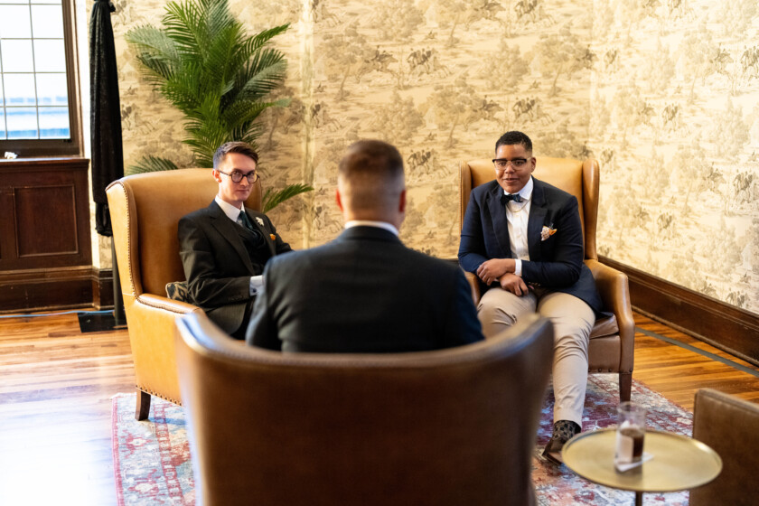 Photo of three people chatting at a cocktail party 