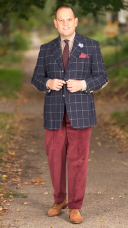 Raphael wearing a blue sport coat and red trousers