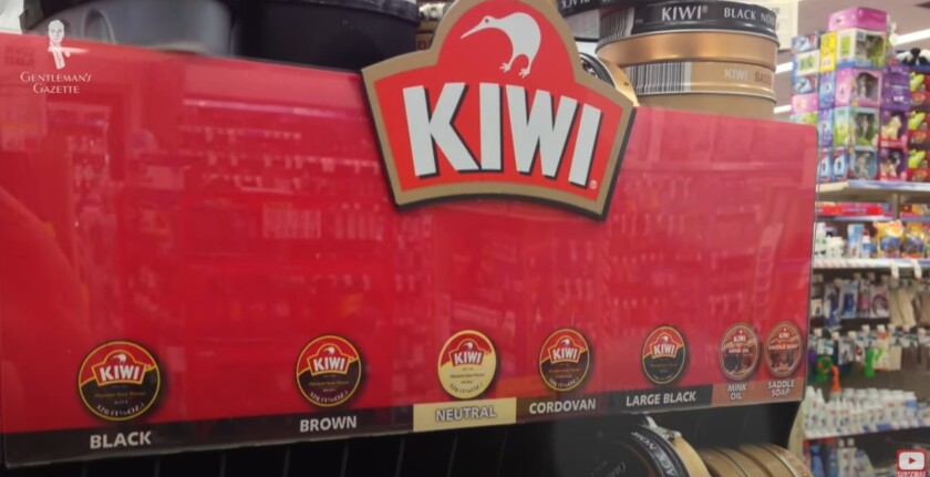 A display stand filled with Kiwi shoe polish tins in a variety of colors