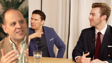 Three men chatting around a table