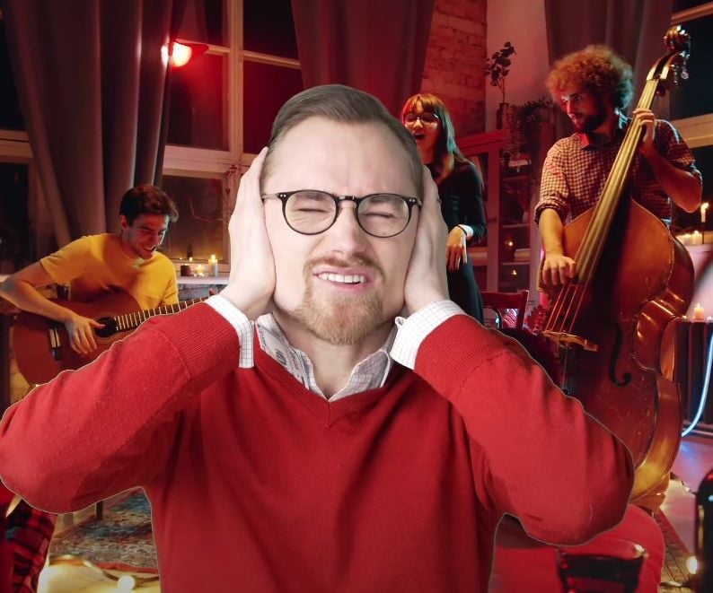 First Date Restaurant Noise Level Tips Preston covering his ears while a loud live band plays in a restaurant
