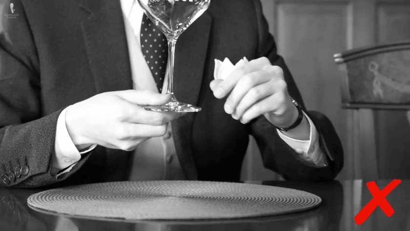 person holding a wine glass in a wrong way