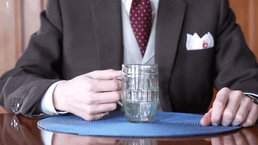 Hand gripping the handle of a beer stein correctly, ready for a sip.