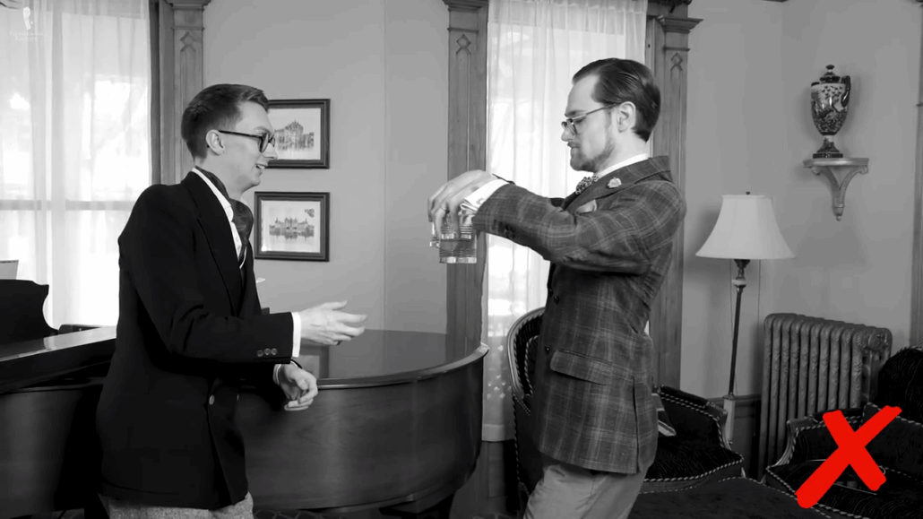 Jack in a plaid jacket receiving four lowball glasses by the rim from Preston