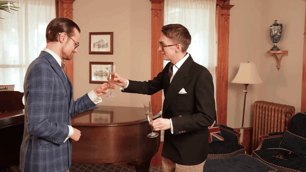 Jack handing a glass to Preston by the stem, ensuring the stem is unobstructed for proper and polite receiving.