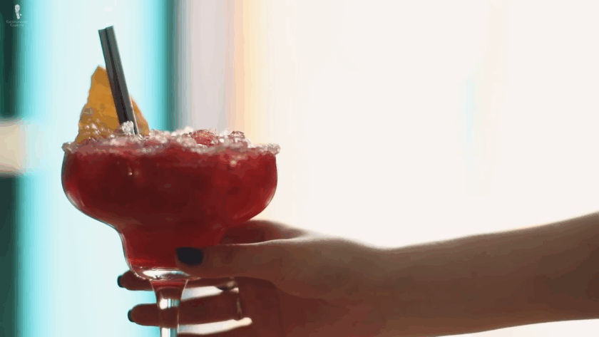 Hand holding a margarita glass securely by the stem