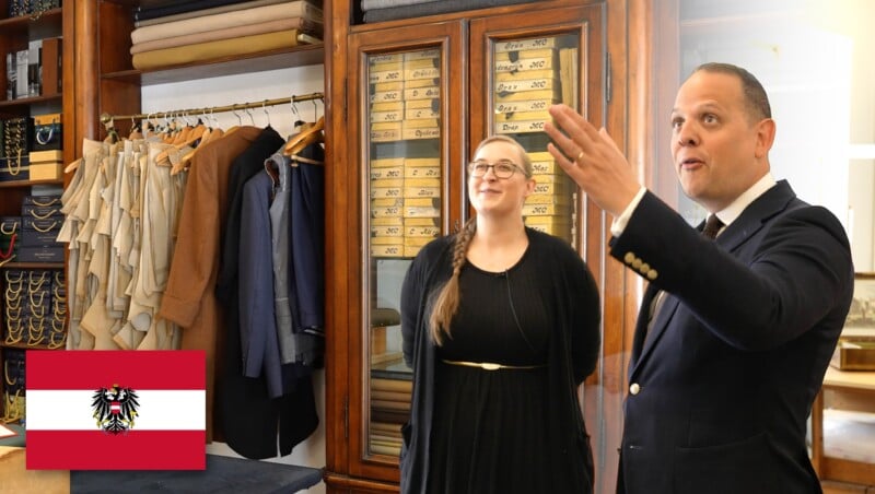 A man and a woman stand in a tailor's shop