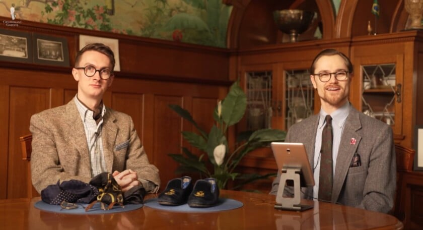 outfit rundown preston jack gendered clothing Jack and Preston seated at a polished wooden table in a formal setting, wearing classic tailored jackets and ties