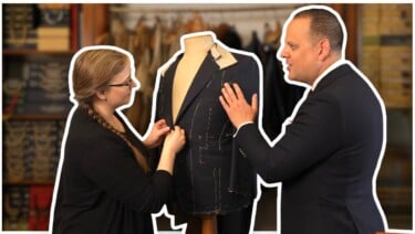 A man and woman chat in front of a mannequin.