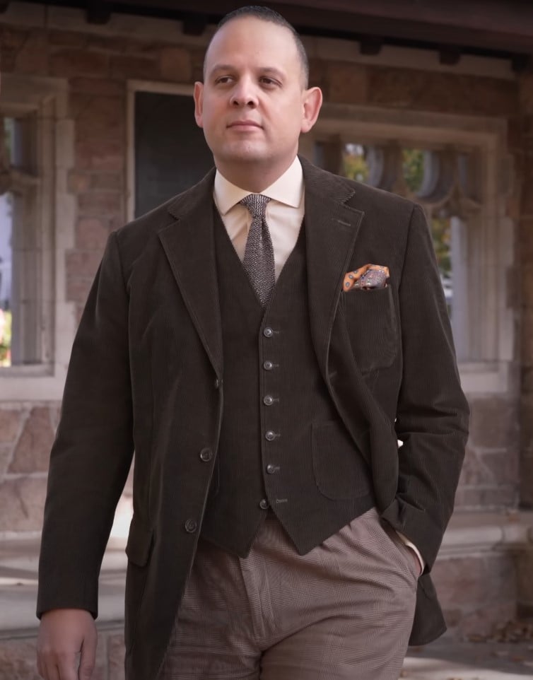 brown corduroy three piece suit pocket square Raphael in brown corduroy three-piece suit with light shirt, patterned tie, and orange silk pocket square.