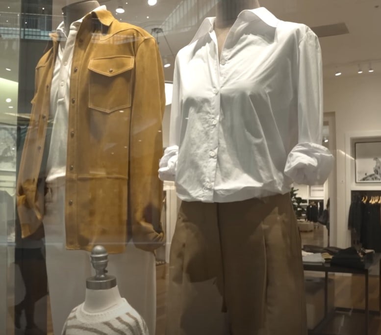 fast fashion profits mass production casual basics Storefront display with mannequins dressed in casual basics.