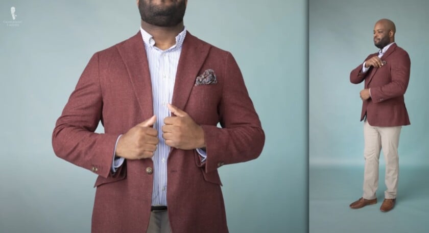 kyle outfit rundown glamorize life Kyle wearing a burgundy blazer with speckles, tan trousers, blue and white striped shirt, and brown loafers, accessorized with a patterned pocket square and striped socks