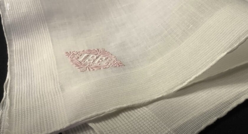 white handkerchief monogram White linen handkerchief with a pink embroidered diamond monogram.