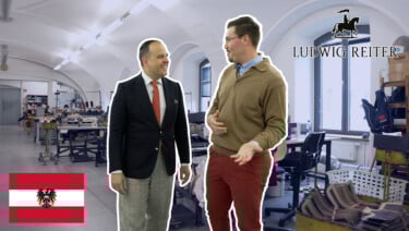 Two men chat in a shoe factory