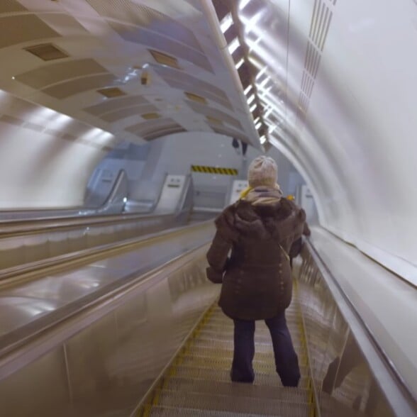 Crowded escalator in the U.S. with people standing on the right to let walkers pass on the left.