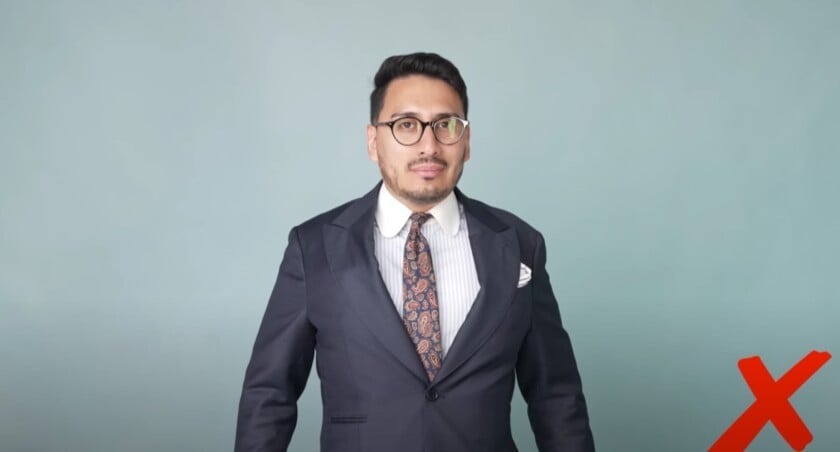 Ivan in a suit standing with puffed-out chest.