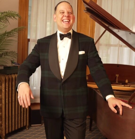 ralph lauren purple label black watch tartan dinner jacket Raphael Schneider standing by a piano wearing a Ralph Lauren Purple Label Black Watch tartan dinner jacket with a shawl collar.